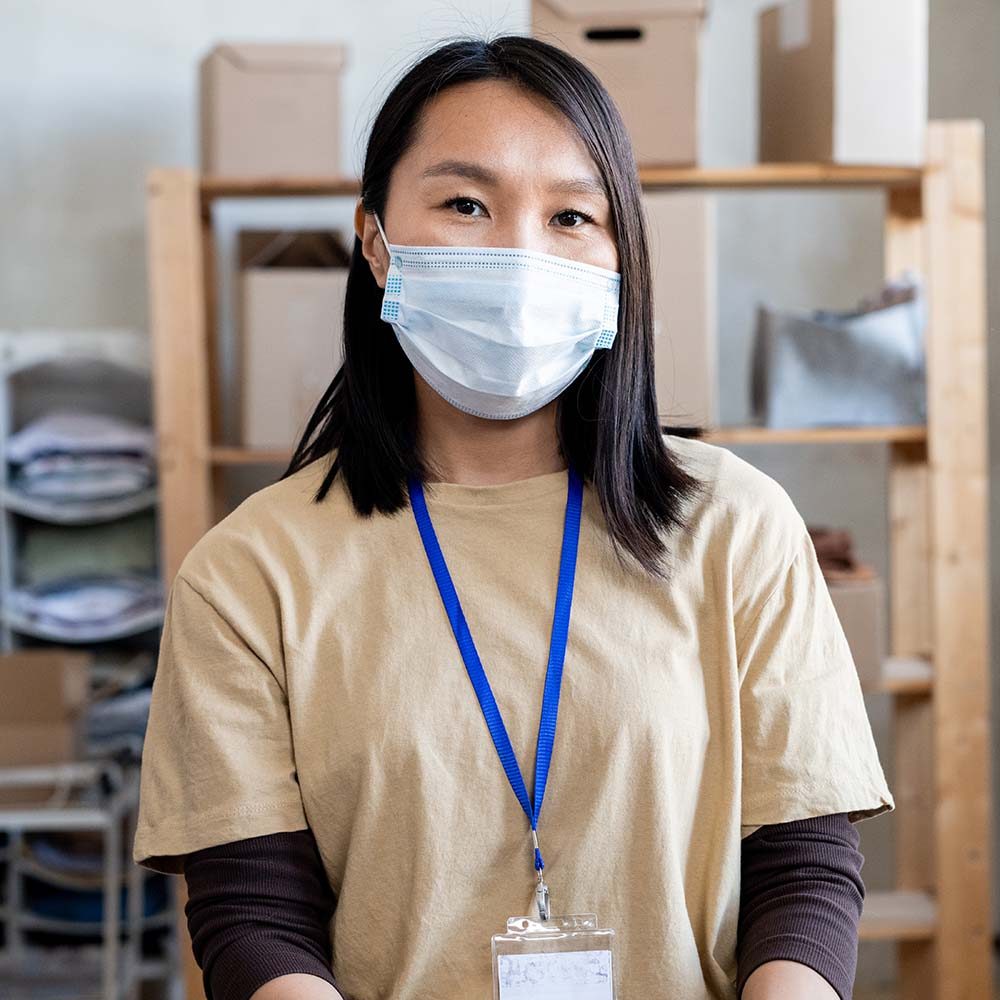 young-asian-female-volunteer-in-mask-and-gloves-SGHBWAP-2.jpg